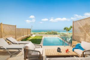 a villa with a swimming pool and a patio at Diamond Star Hotel in Falasarna