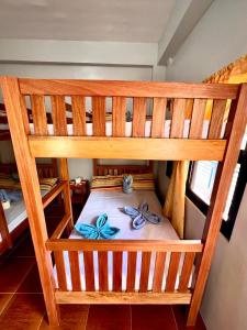 a bunk bed with two pairs of shoes on it at Lotus Sun & Waves Beach Resort in Baler