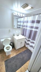 a bathroom with a white toilet and a sink at City Views Penthouse NYC in 5min in Hoboken