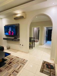 salon z telewizorem z płaskim ekranem na ścianie w obiekcie درر بيروت للوحدات السكنية w mieście Dżudda