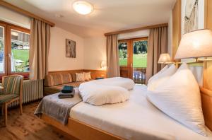 Habitación de hotel con cama y sofá en Oberlehenhof en Kaprun