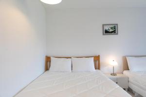 a white bedroom with a bed and a couch at Walking Sky Pension in Gapyeong