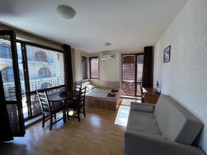 a living room with a couch and a table at Apartments Amara Sunny Beach in Sunny Beach