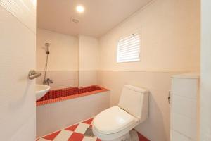 a bathroom with a toilet and a sink at Walking Sky Pension in Gapyeong