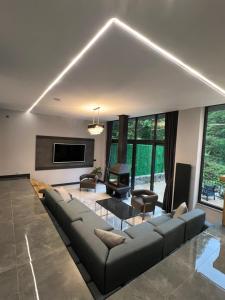 a living room with a couch and a fireplace at Yesilvadi Otel 4M LUXURY in Ayder Yaylasi