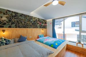 a bedroom with a bed and a large window at Starstay Wuling Mountain B&B in Xinglong