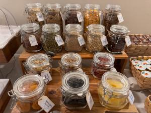 a table filled with jars of food with labels at Hotel Quisisana in Riccione