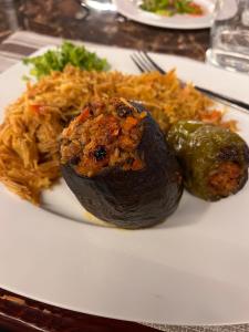 a plate of food with a vegetable and rice at Deep Ashri Star House Hotel in Marsa Alam City