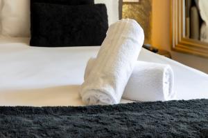 a roll of toilet paper sitting on a bed at Milestone in Quartu SantʼElena