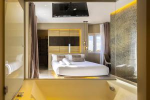 a bedroom with a large white bed in a mirror at Milestone in Quartu SantʼElena