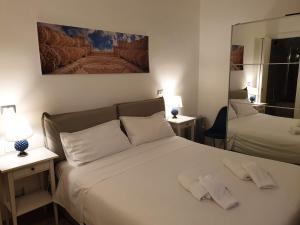 a bedroom with two beds with white pillows at Casa Sveva in Siracusa