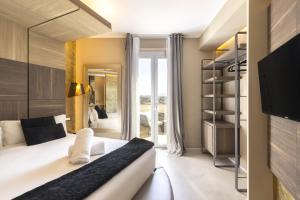 a bedroom with a bed and a large window at Milestone in Quartu SantʼElena