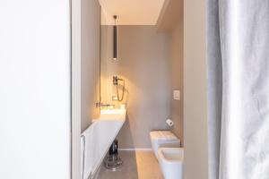 a bathroom with a sink and a toilet at Milestone in Quartu SantʼElena