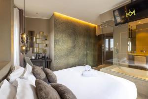 a bedroom with a bed and a bath room with a tub at Milestone in Quartu SantʼElena