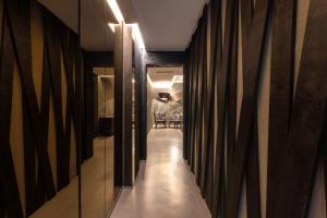 a hallway with a long corridor with wooden walls at Milestone in Quartu SantʼElena
