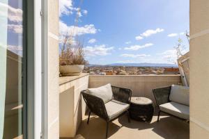 a balcony with two chairs and a table at Milestone in Quartu SantʼElena