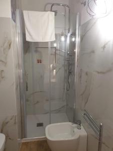 a bathroom with a shower and a toilet and a sink at Casa Sveva in Siracusa