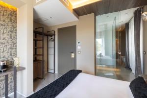 a bedroom with a king sized bed and a bathroom at Milestone in Quartu SantʼElena