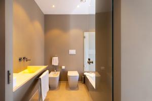 a bathroom with a sink and a toilet at Milestone in Quartu SantʼElena