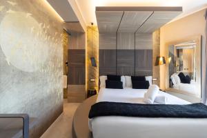 a bedroom with a large white bed in a room at Milestone in Quartu SantʼElena