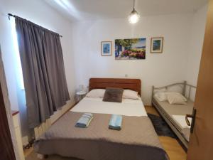 Postel nebo postele na pokoji v ubytování Apartmani Tereza + 37 fotografií