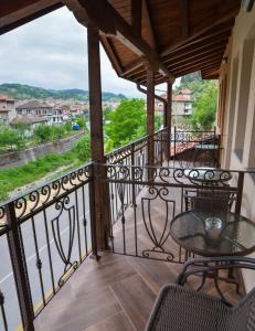 a balcony with a table and chairs and a view at Надежда - Златоград in Zlatograd +6 photos