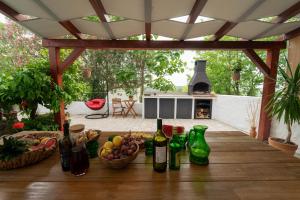 a wooden table with bottles of wine on a patio at Green & blue in Ražanac