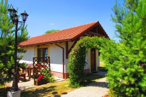 ein kleines weißes Haus mit rotem Dach in der Unterkunft Chata u vinára Milana, Tatralandia in Liptovský Mikuláš