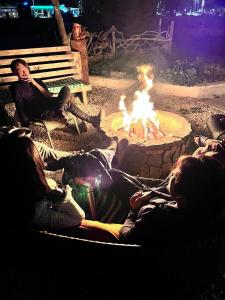a group of people sitting around a fire pit at CAMP&HOSTEL Antalya in Antalya
