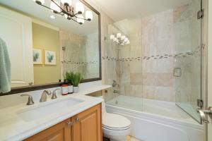 a bathroom with a sink and a toilet and a shower at Spacious Cozy House in Vancouver West in Vancouver