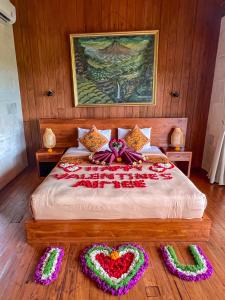 a bedroom with a bed with heart decorations on it at Made Punias Jungle Paradise in Ubud