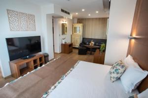 una camera d'albergo con un letto e una TV a schermo piatto di Family Hotel Berlin Beach Sveti Vlas a Sveti Vlas