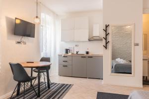 a kitchen and dining room with a table and chairs at OLD TOWN PULA STUDIO APARTMENTS in Pula