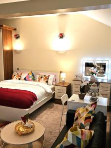 a bedroom with a bed and a living room at HEATHROW MANSION SHUTTLES in Uxbridge