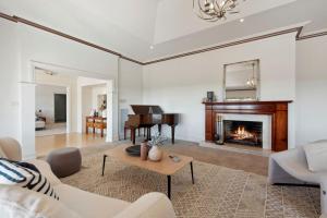 a living room with a fireplace and a piano at Sommerville Majestic Farm Manor Retreat 5bd 3Bth Pool Spa in Somerville