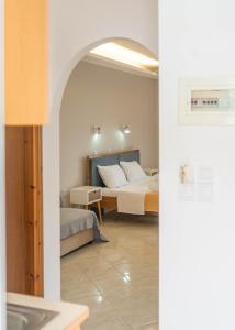 a hotel room with a bed and a bathroom at Ermioni Rooms in Paralia Vrachou +25 photos