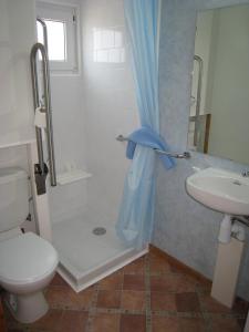a bathroom with a shower and a toilet and a sink at Camping Sitges in Sitges