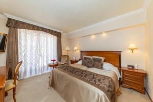 a hotel room with a bed and a window at Hotel Niko in Zadar