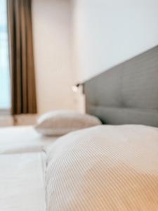 a close up of a bed in a bedroom at Alpha Hotel in Ostend