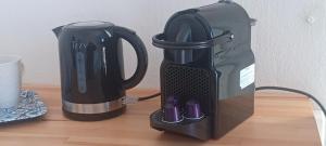 affeepot and a coffee maker sitting on a table at AGORA CENTER Building - Room 20 in Ios Chora