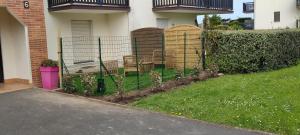 a fence in front of a house with chairs at Cabourg Plage in Cabourg