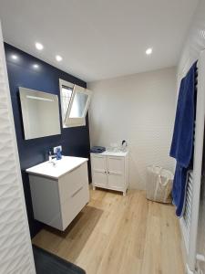 a bathroom with a white sink and a mirror at Chaguimama Sea in Begur
