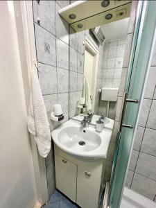 a bathroom with a sink and a mirror at Vemar Apartment - Near the beach, Private parking in Dubrovnik