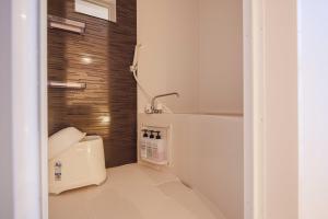 Postel nebo postele na pokoji v ubytování Miro Hotel Momodanikoen-mae