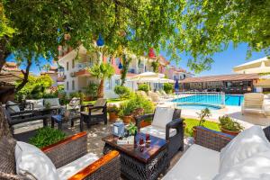 an outdoor patio with chairs and a pool at Safak Oasis Hotel in Dalyan
