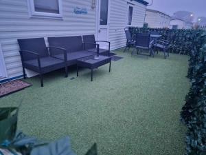 a patio with chairs and a table on a house at Sunnyside - Pet friendly, Ingoldmells in Ingoldmells