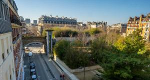 a view of a city with a bridge and buildings at 26 Faubourg - Ex-Hotel de Reims in Paris