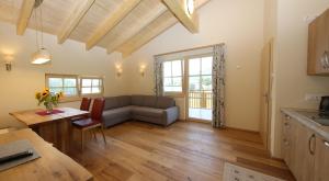 a living room with a couch and a table at Alpenperle in Ramsau am Dachstein