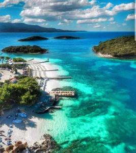 an aerial view of a beach with blue water at Guesthouse Emanuel in Ksamil