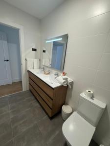 a bathroom with a sink and a toilet and a mirror at Apartamentos Arcos de Montemar in Torremolinos +13 photos